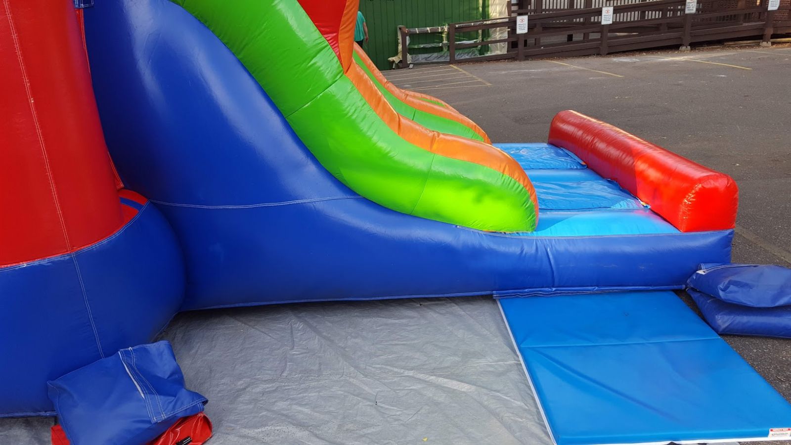 Bounce house exit surrounded by mats for safety
